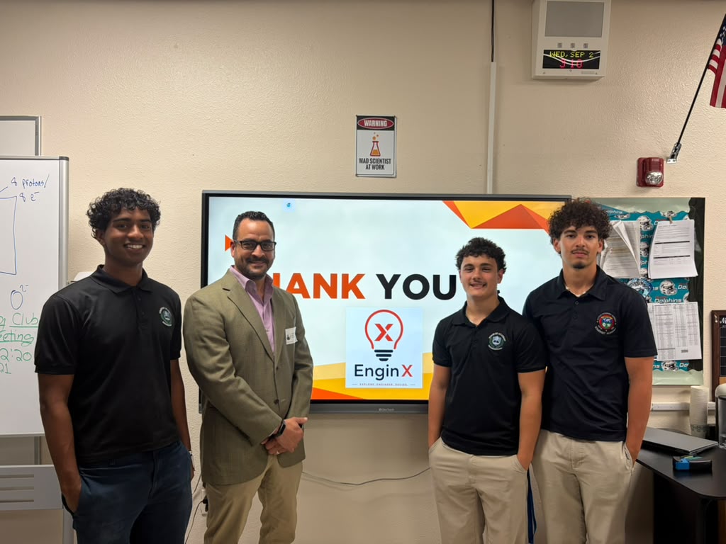 EnginX students standing with guest speaker Gabriel Mejia in front of a thank-you slide after the Industrial Engineering Workshop